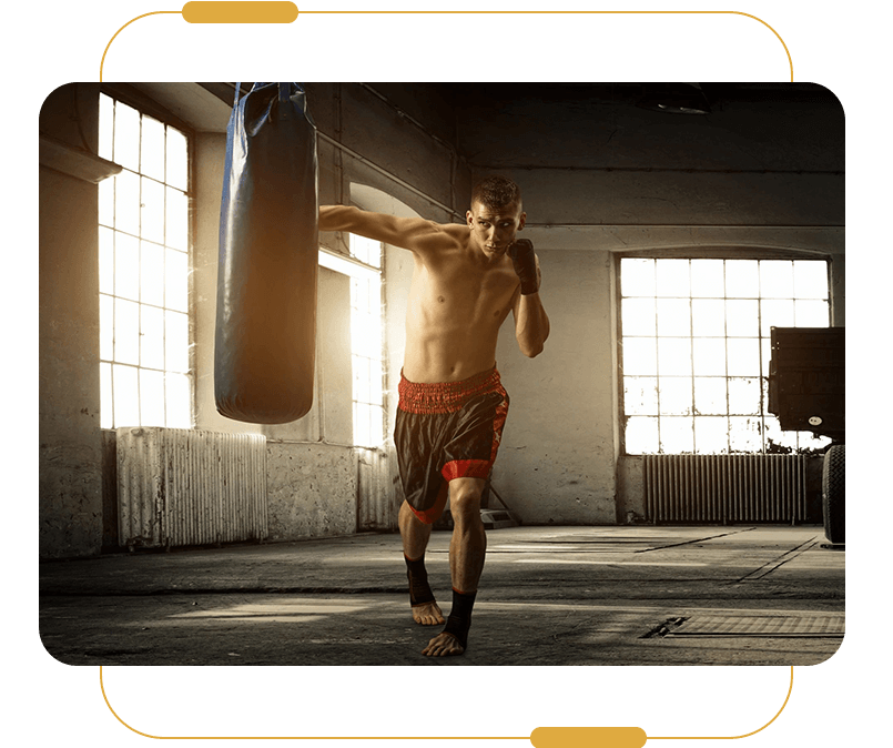 A man is boxing in an old building